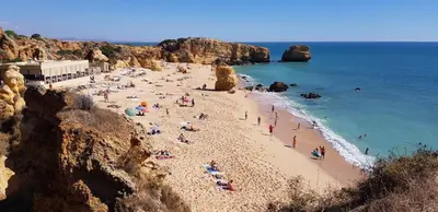 a group of people on a beach near the ocean at Sao Rafael T2 Duplex, Albufeira in Albufeira