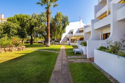 a wooden table on a balcony with a tableablish at BnBird Exclusive Oasis in Vilamoura in Quarteira