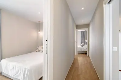 a small bedroom with a bed and a hallway at A Casa da Elsa in Faro