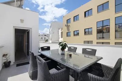 a balcony with two chairs on a building at A Casa da Elsa in Faro