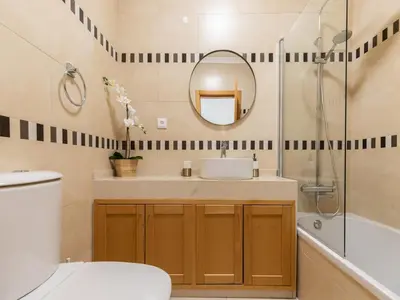 a bathroom with a sink and a mirror at Akisol Olhos de Água Lyrical in Albufeira