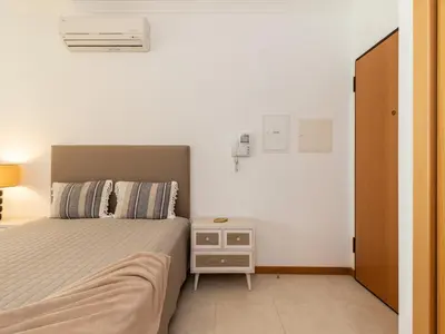 a small bedroom with a bed and a night stand at Akisol Olhos de Água Lyrical in Albufeira
