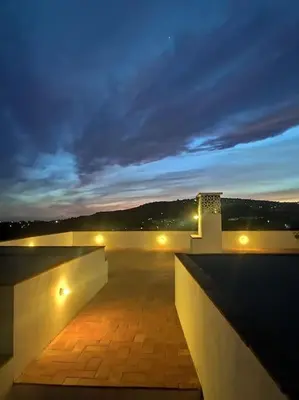 a night view of a balcony with lights at Eco-Villa Monte Do Barrocalinho in Loulé