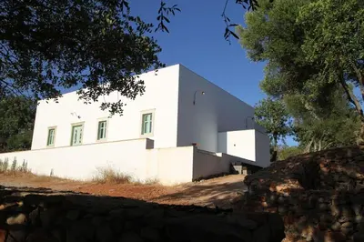 a white building on top of a hill at Eco-Villa Monte Do Barrocalinho in Loulé