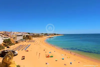 a beach with a lot of people and the ocean at SÃO RAFAEL BEACH VILLAGE 131 - Apartamento T2 Praia de São Rafael - Albufeira in Albufeira