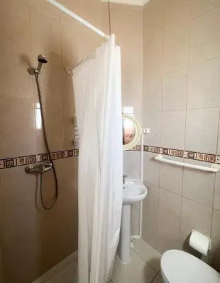 a bathroom with a shower and a sink and a toilet at Casa Clementina in Albufeira