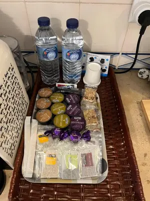 a tray with two bottles of water and donuts at LV Apartment Albufeira in Albufeira