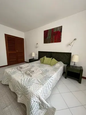 a bedroom with a large bed and two night stands at LV Apartment Albufeira in Albufeira