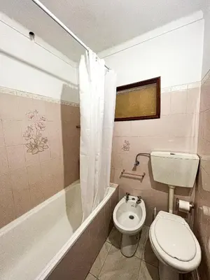 a bathroom with a toilet and a tub and a sink at Casa Maria in Albufeira