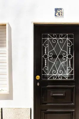a black door with a wrought iron gate at Casa Maria in Albufeira