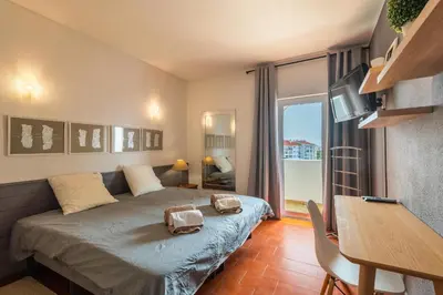 a bedroom with a bed with two bags on it at Sea View Central Town 2 Bedroom Apartment in Albufeira