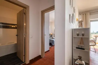 a candle on a table next to a green plant at Sea View Central Town 2 Bedroom Apartment in Albufeira