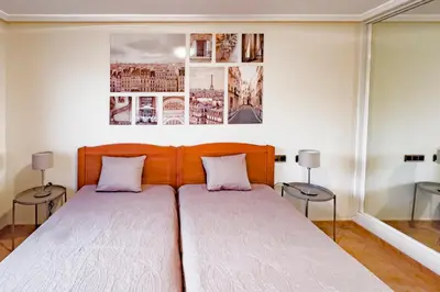 a bedroom with a large bed with two tables at Pine Sun Park Т1 apartment Falesia beach in Olhos de Água