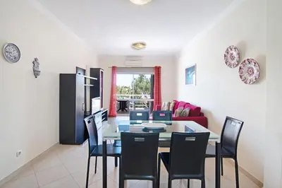 a kitchen and dining room with a table and chairs at Yara Beach Apartments T1 in Albufeira