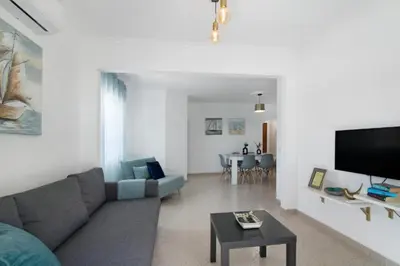 a living room with a couch and a table at Apartamento Jade by Sunnyway in Albufeira