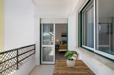 a balcony with a plant in a white vase at Apartamento Jade by Sunnyway in Albufeira