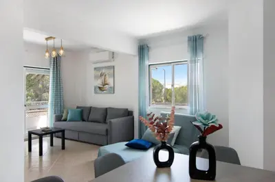 a living room with a couch and a table at Apartamento Jade by Sunnyway in Albufeira