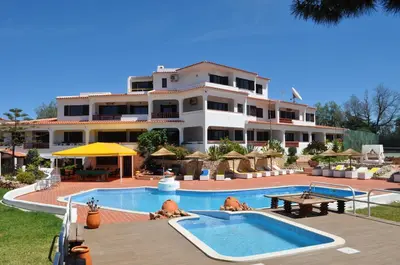 a hotel with a swimming pool and a building at Casa Areias Boutique Apartments in Albufeira