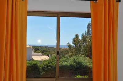 an open window with an orange curtain at Casa Areias Boutique Apartments in Albufeira
