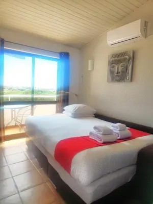 a bedroom with a bed and a window with a mask at Casa Areias Boutique Apartments in Albufeira