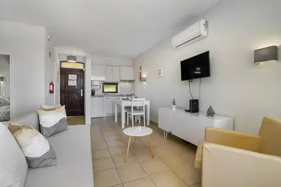 a white living room with a couch and a table at Garden Paradise, Old Town & Beach in Albufeira