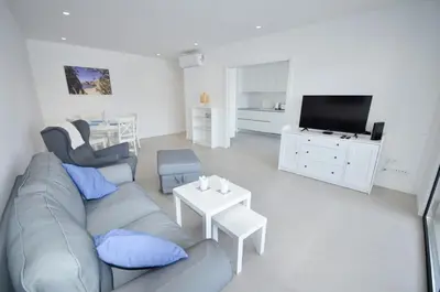 a living room with a couch and a tv at Blue Horizons, (AT18) 2 Bedroom, Olhos de Agua in Olhos de Água