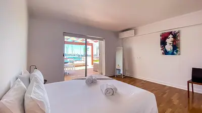 a white bedroom with a bed with towels on it at Que sonho! Vista Marina T2 HsR Vilamarina in Vilamoura