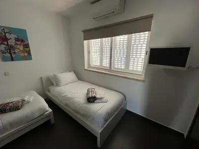 a small room with two beds and a window at House´s Golf in Almancil