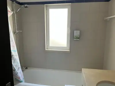 a bathroom with a white tub and a window at House´s Golf in Almancil