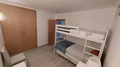 a small room with two bunk beds in it at Casa Azinheira - Albufeira in Albufeira