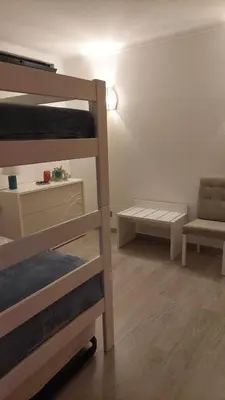 a room with two bunk beds and a chair at Casa Azinheira - Albufeira in Albufeira