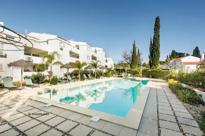 an image of a swimming pool in front of a building at Appartement Vale Lobo Mer Golf & Belle Piscine in Vale do Lobo