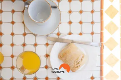 a table with a plate of bread and a cup of coffee at #166 Frat Apartment by Home Holidays in Albufeira