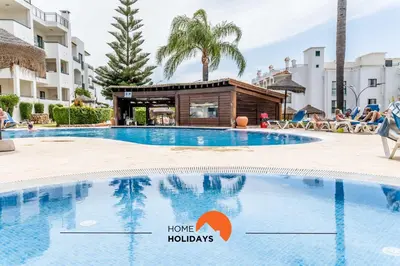 a swimming pool at a resort with a hotel with the words home holidays at #166 Frat Apartment by Home Holidays in Albufeira