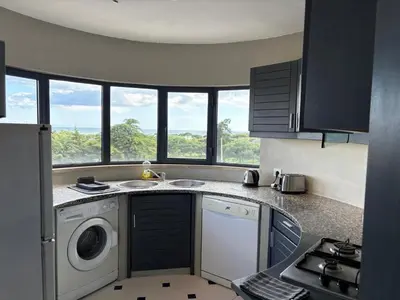 a kitchen with a sink and a washing machine at Coral By Albufeira Rental in Albufeira