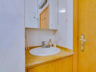a bathroom with a white sink and a mirror at AL - Quarteira Terrace Penthouse in Quarteira