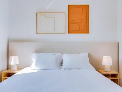 a bedroom with a white bed with two lamps at AL - Quarteira Terrace Penthouse in Quarteira
