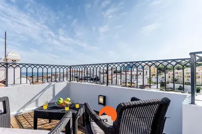 a balcony with a table and chairs and a view of the city at #164 Saradel 42 by Home Holidays in Albufeira