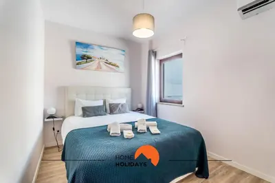 a bedroom with a bed with two slippers on it at #164 Saradel 42 by Home Holidays in Albufeira