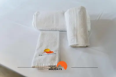two towels sitting on a table with a picture at #164 Saradel 42 by Home Holidays in Albufeira