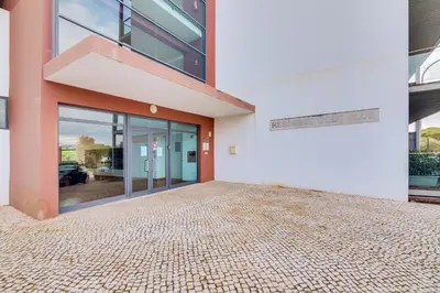 an empty building with a large glass door at AL - Residence Golf Club Modern Apartment in Vilamoura