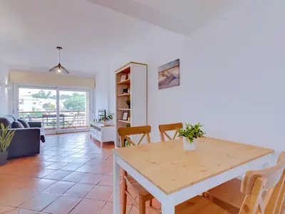 a kitchen and living room with a table and chairs at AL - Apartamento Village Atlântico in Vilamoura