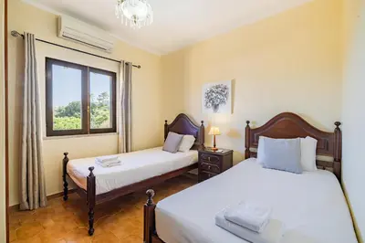 a bedroom with a bed with two towels on it at Villa Pinheiro in Albufeira