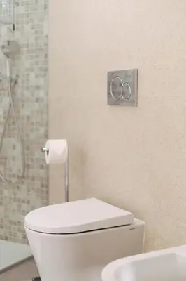 a bathroom with a white toilet and a shower at Orange Boutique Residence - Casa Diogo in Quarteira