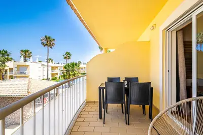 a balcony with chairs and a table on a balcony at BeGuest Jardins Vale Parra Apartment in Albufeira
