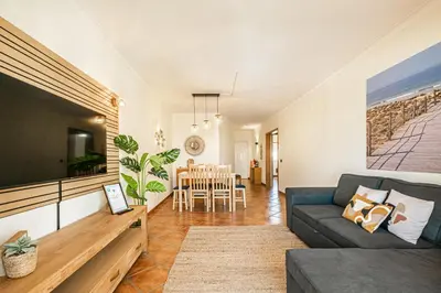 a living room with a couch and a flat screen tv at BeGuest Jardins Vale Parra Apartment in Albufeira