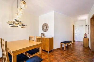 a dining room with a wooden table and chairs at BeGuest Jardins Vale Parra Apartment in Albufeira