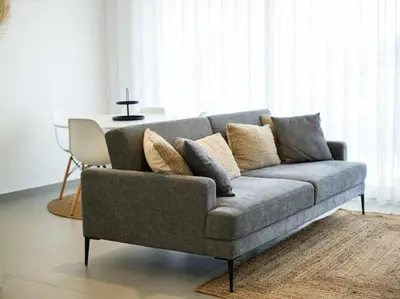 a grey couch in a living room with a table at Green 1 Apartment by Stay ici Algarve Holiday Rental in Albufeira