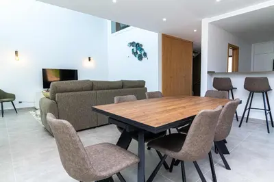 a dining room with a table and chairs and a couch at Villa Orada 25 by Stay ici Algarve Holiday Rental in Albufeira