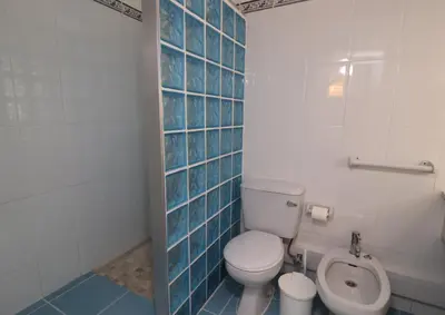 a bathroom with a toilet and a urinal at Camelia 52 Beach Studio Apartment - São Rafael, Albufeira in Albufeira